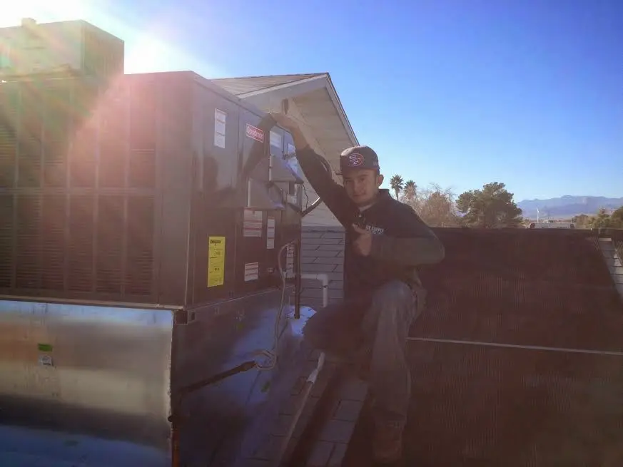 HVAC technician performing Heat Pump Repair on a rooftop unit in Scotch Plains